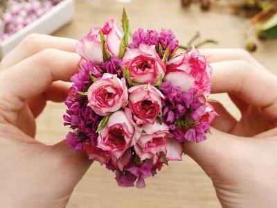 Hands creating bouquet