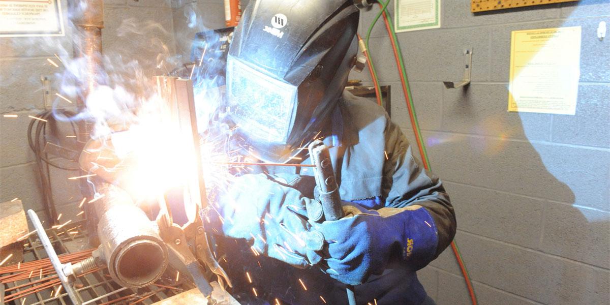AACC welding student with torch
