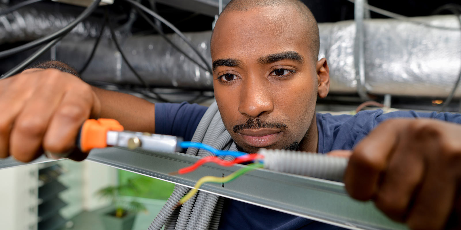 Man works on electrical project.